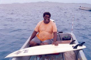 Big John posing with my surfboard on his boat