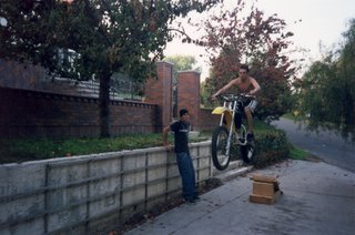 My brother, Joel, jumping his motorcycle in the driveway