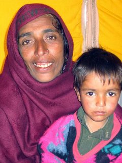 Gulzar, whose family died before her eyes, walked seven days to reach this tent village. Shown here with a surviving nephew.