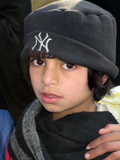 A young Pakistani girl at one of World Vision’s Child Friendly Spaces in Balakot sports a New York Yankees baseball cap.