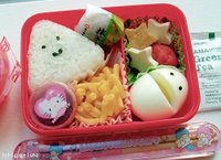 A Hello Kitty meal which includes egg, rice, fried tofu, cheese, umeboshi and cake