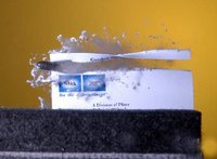 Bullet passing through a sheet of paper.