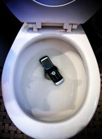 Cellphone in a toilet bowl.