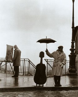 Musician in the Rain by Robert Doisneau
