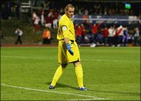 Paul Robinson lets Gary Neville's pass into the England goal