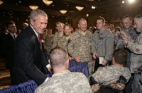 President George W. Bush is greeted by military personnel following his address on the global war on terror at the Military Officers Association of America meeting Tuesday, Sept. 5, 2006, at the Capital Hilton Hotel in Washington. President Bush spoke about the U.S. and allies strategy for combating terrorism saying 'we're confronting them before they gain the capacity to inflict unspeakable damage on the world, and we're confronting their hateful ideology before it fully takes root.' White House photo by Kimberlee Hewitt