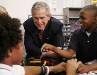President George W. Bush talks with students during his visit Thursday, Oct. 5, 2006, in the SmartLab of the Woodridge Elementary and Middle Campus in Washington, D.C., where students demonstrated various math, science and technology projects. White House photo by Paul Morse.