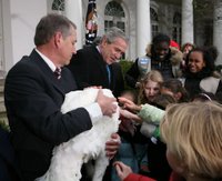 President George W. Bush invites children to meet 'Flyer' the turkey, held by Lynn Nutt of Springfield, Mo., during a ceremony Wednesday, Nov. 22, 2006 in the White House Rose Garden, following the President’s pardoning of the turkey before the Thanksgiving holiday. White House photo by Paul Morse.
