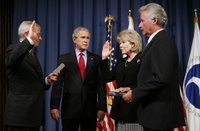 President George W. Bush attends the ceremonial swearing-in of Mary Peters as the 15th U.S. Secretary of Transportation, Tuesday, Oct. 17, 2006 at the Department of Transportation in Washington, D.C., as White House Chief of Staff Josh Bolten administers the oath of office and Peter’s husband, Terryl 
