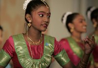 A student from the Bukit View Primary School in Singapore performs a cultural dance with classmates for President George W. Bush and Mrs. Laura Bush during their visit Thursday, Nov. 16, 2006, to the city's Asian Civilisations Museum. White House photo by Paul Morse.