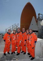 Image: With the final launch rehearsal completed, the STS-115 crew gathers on the 215-foot level of the fixed service structure on Launch Pad 39B. From left are Pilot Christopher Ferguson, Mission Specialists Heidemarie Stefanyshyn-Piper and Joseph Tanner, Commander Brent Jett, and Mission Specialists Steven MacLean and Daniel Burbank. Photo credit: NASA/Cory Huston.