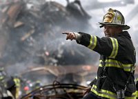Retired fire chief Joseph Curry barks orders to rescue teams as they clear through debris that was once the World Trade Center Sept. 14, 2001, in New York. Photo by Photographer's Mate 1st Class Preston Keres, USN