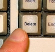 Finger pressing 'Delete' key
