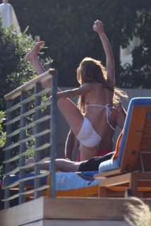 Linday Lohan - stretches in bikini
