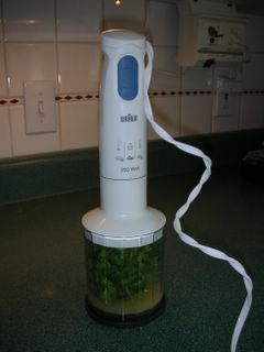 A favorite kitchen tool, an immersion blender, shown here with the food processor cup attached
