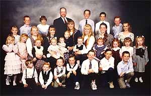 Tom Green (top centre left) with his family in a photograph that was presented to the jury during his polygamy trial. Green, 52, who has five wives and at least 29 children, faces charges of bigamy and failing to pay child support in Utah's first polygamy trial in nearly 50 years. He could get up to 25 years in prison and $25,000 in fines. Photo: AP