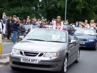 Gala Queen in back of car waving to the crowd