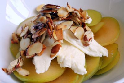 photograph picture of green pluot, panir cheese and honeyed almonds