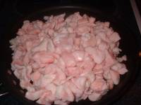 cooking the diced fat in heavy skillet over low heat