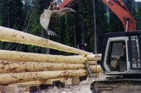 Excavator aids Log Construction