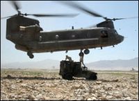 Soldiers sling-load a vehicle to a CH-47 Chinook helicopter during an operation near Bagram, Afghanistan. The Soldiers are assigned to the 25th Infantry Division, supporting the Joint Logistics Command during Operation Enduring Freedom. This photo appeared on www.army.mil. July 29, 2004 by Sgt. 1st Class Sandra WatkinsKeough