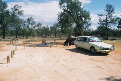 Car and tent in arid zone