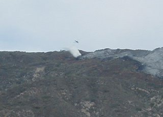 helicopter dropping water on fire
