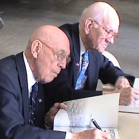 Dick Cole and Thomas Griffin, two of the 15 remaining Doolittle Raiders, sign copies of a book I bought in the gift shop, 'Destination: Tokyo', March 3, 2007