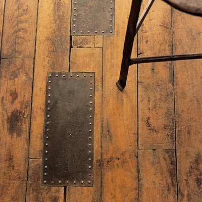 old wooden floor with metal plates