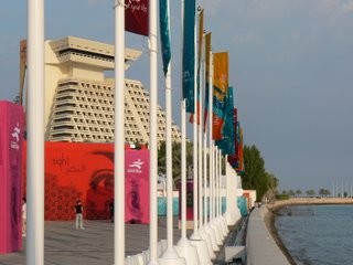 flags wave along the edge of the Corniche