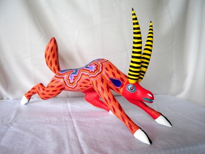 Pale Horse Galleries, http://palehorsemex.vstore.ca/, For gifts, collectibles, Mexican arts and crafts. 'Antelope del Sol by Zapotec srtists Felipe and Lucila Zarate of Arrazola, Xoxocotlan, Oaxaca, Mexico. A hand carved and hand painted antelope in the distinctive Zapotec style.