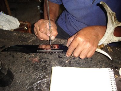 Mark in Mexico, http://markinmexico.blogspot.com/ Pale Horse Galleries for gifts, collectibles, Mexican arts and crafts, http://palehorsemex.vstore.com/ palehorsemex.blogspot.com/ Angel Aguilar pictured free-hand lettering a hand forged and tempered knife blade with masking paint, prior to etcheing, in Ocotlan, Oaxaca, Mexico.