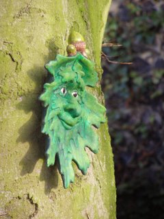 A ceramic face on a tree