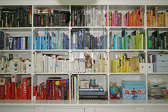 books arranged on bookshelves by color