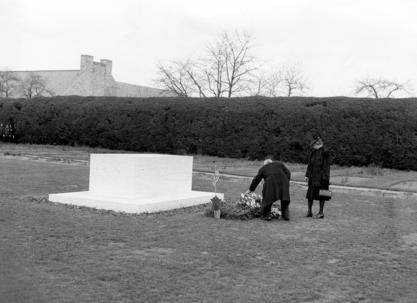 President Harry S Truman with Mrs. Roosevelt placing flowers at FDR"s grave
