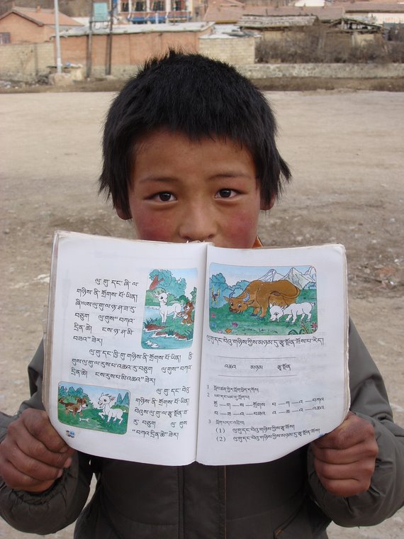 Little Tibetan proudly presenting his school book