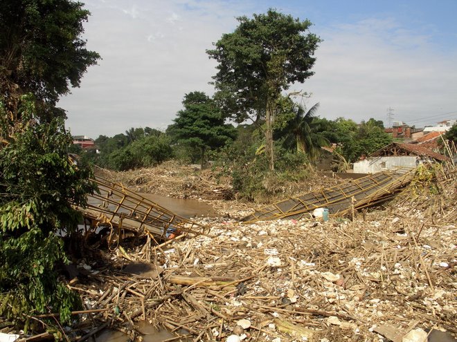 Steel suspended pedestrian bridge takend out by wall of garbage, Ciliwung River, Pasar minggu