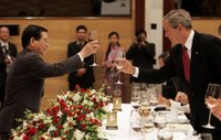 President George W. Bush exchanges toasts with Viet President Nguyen Minh Triet during a State Banquet Friday, Nov. 17, 2006, at the International Convention Center in Hanoi. President Bush told his host, 'Vietnam is a country that's taking its rightful place as a strong and vibrant nation,' adding he hoped its people know they have the friendship of the American people. White House photo by Paul Morse.