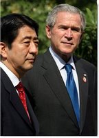 President George W. Bush and Prime Minister Shinzo Abe of Japan talk with the media during a photo opportunity Saturday, Nov. 18, 2006, following their lunch at the Sheraton Hanoi hotel. White House photo by Eric Draper.