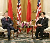 President George W. Bush and President Hu Jintao of China pause for photos after their bilateral talks Sunday, Nov. 19, 2006, at the Hanoi Daewoo Hotel in Hanoi. White House photo by Eric Draper.