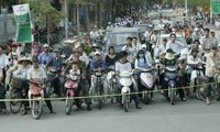 Pedestrians and cyclists line the motorcade route in Hanoi as President George W. Bush and Mrs. Laura Bush head to the Sheraton Hanoi Hotel Friday, Nov. 17, 2006, after their arrival in Vietnam. White House photo by Paul Morse.