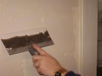Rob fills cracks in kitchen wall plaster