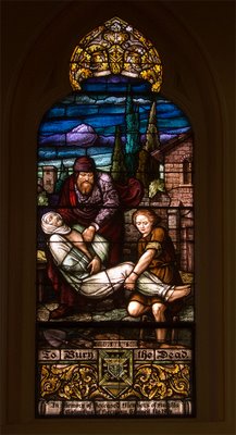 Saint George Catholic Church, in Hermann, Missouri - stained glass window: burying the dead