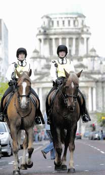 Two policewomen on horseback against the backdrop of City Hall