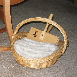 Basket of handcarded noil rolags.