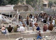 Pakistani tribesmen search a house that was destroyed after an airstrike in Damadola, January 14, 2006. REUTERS/Ali Imam