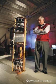 Ballbot balancing in the CMU motion capture lab, with Ralph Hollis looking on.