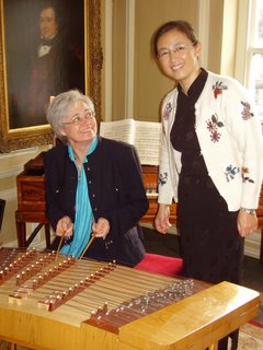 Cllr Sue Derbyshire recieves in struction on the playing of the gu zheng