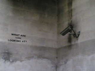 CCTV camera pointing at top of blank wall
