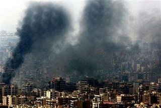 Smoke billows from burning buildings destroyed during an overnight Israeli air raid on Beirut's suburbs August 5, 2006. Many buildings were flattened during the attack. REUTERS/Adnan Hajj 